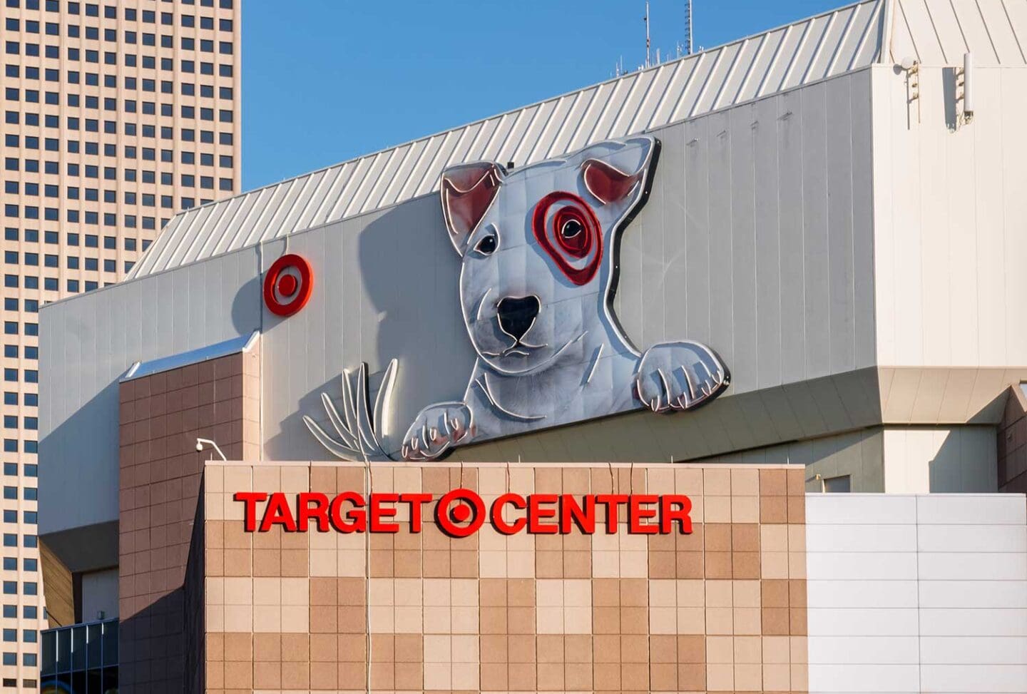 The exterior of Target Center features a large 3D dog sculpture with a red bullseye, the Target logo, and bold red TARGET CENTER signage on the building.