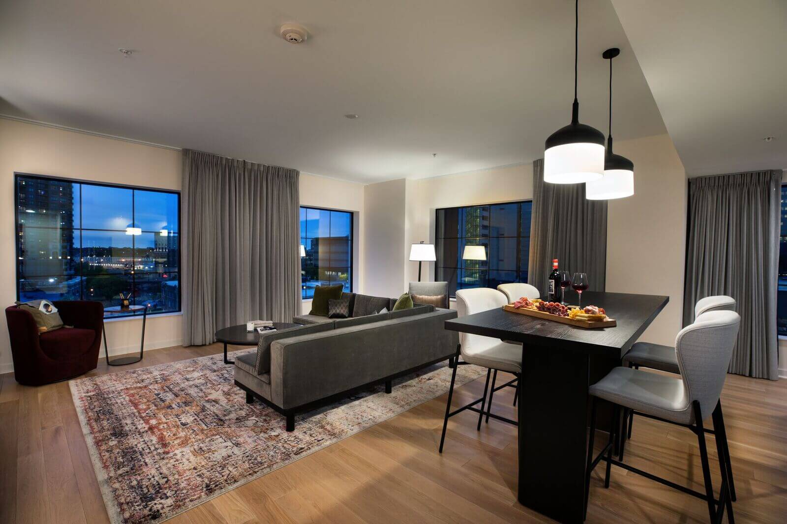 A living room with a table and chairs.